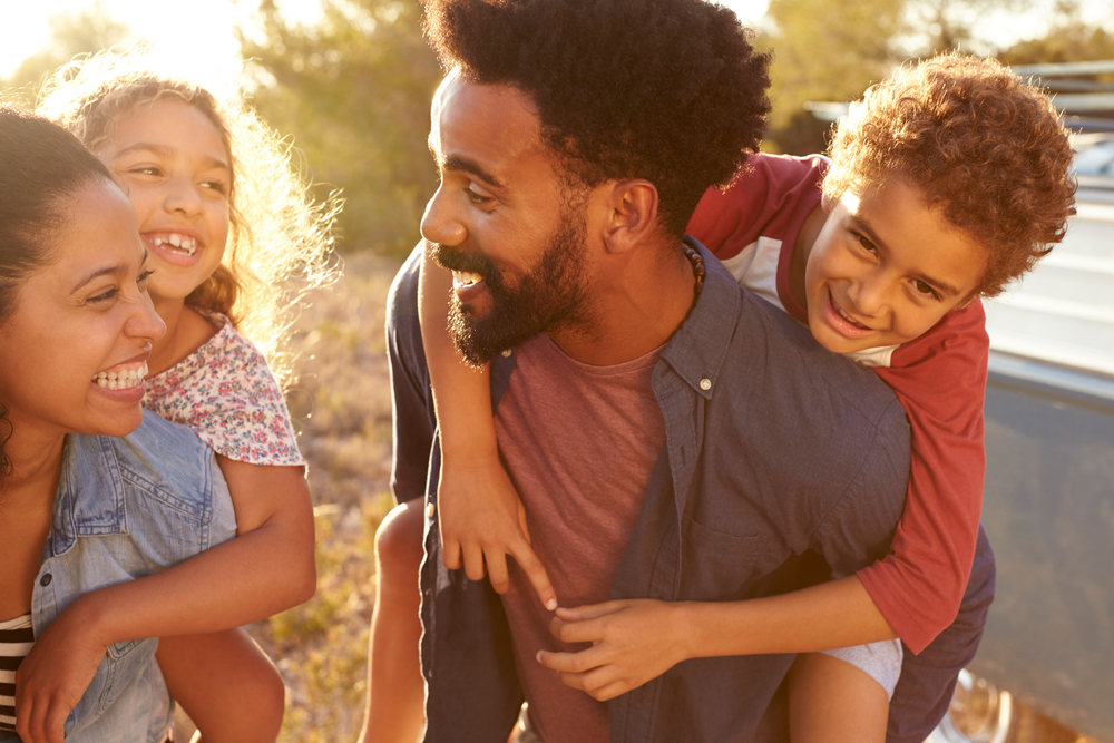 Family Smiling In The Sunlight